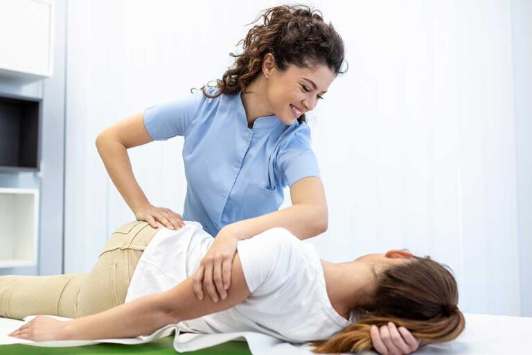 A person receives a gentle chiropractic adjustment while tissues and allergy medicine sit nearby on a table.